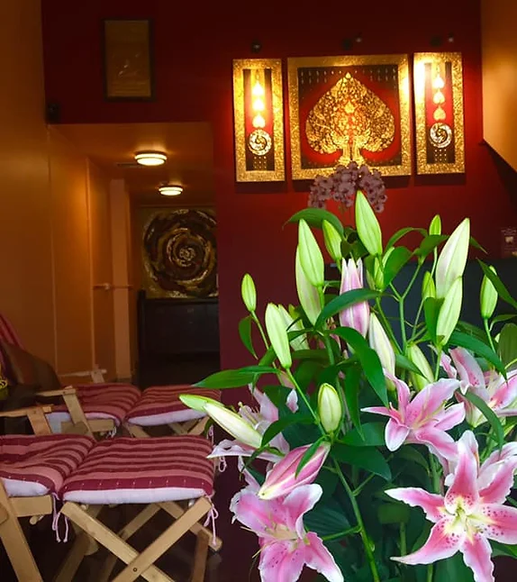 a large vase filled with pink lilies in a room at Nakhon Thai Massage in Parnell Auckland, the Best Thai Massage in Auckland